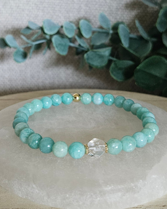 Amazonite Still bracelet with 6mm turquoise gemstone beads, Clear Quartz hexagon focal and 14k gold-plated accents displayed on selenite