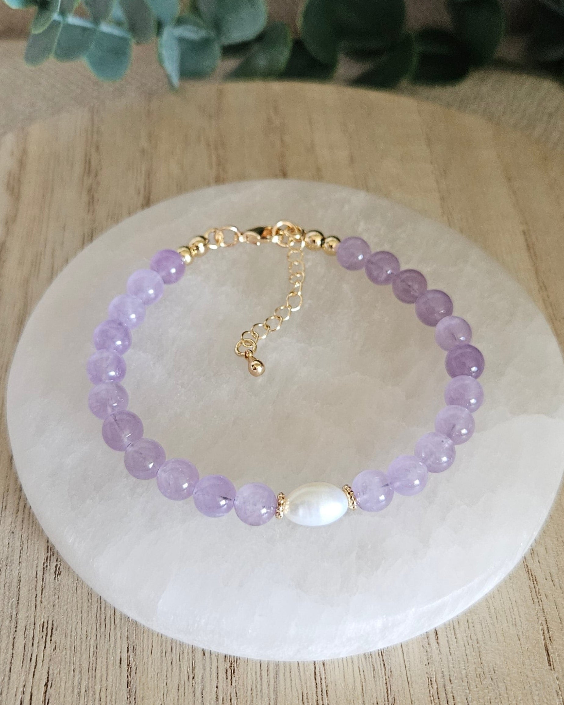 Overhead view of the Lavender Amethyst Embrace bracelet with freshwater pearl focal, clasp and extender chain