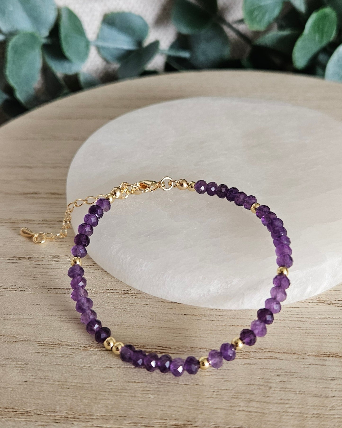 Closer overhead view of the Amethyst bracelet showing the gold-plated clasp and extender chain