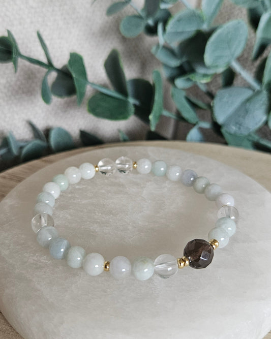 Still Point Burmese Jade and Clear Quartz bracelet with a faceted Smoky Quartz focal and gold accents on selenite
