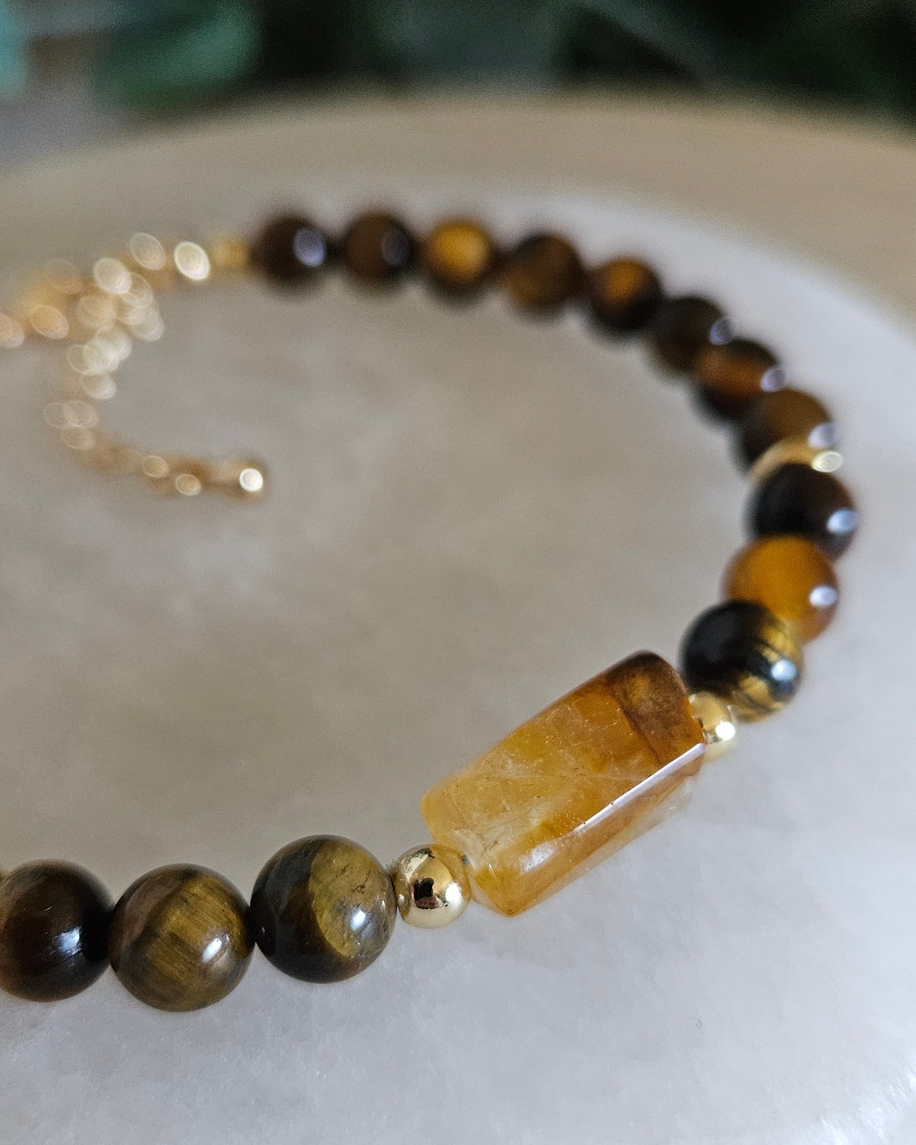 Detailed view of the translucent Citrine focal between polished Tiger’s Eye beads and gold accents