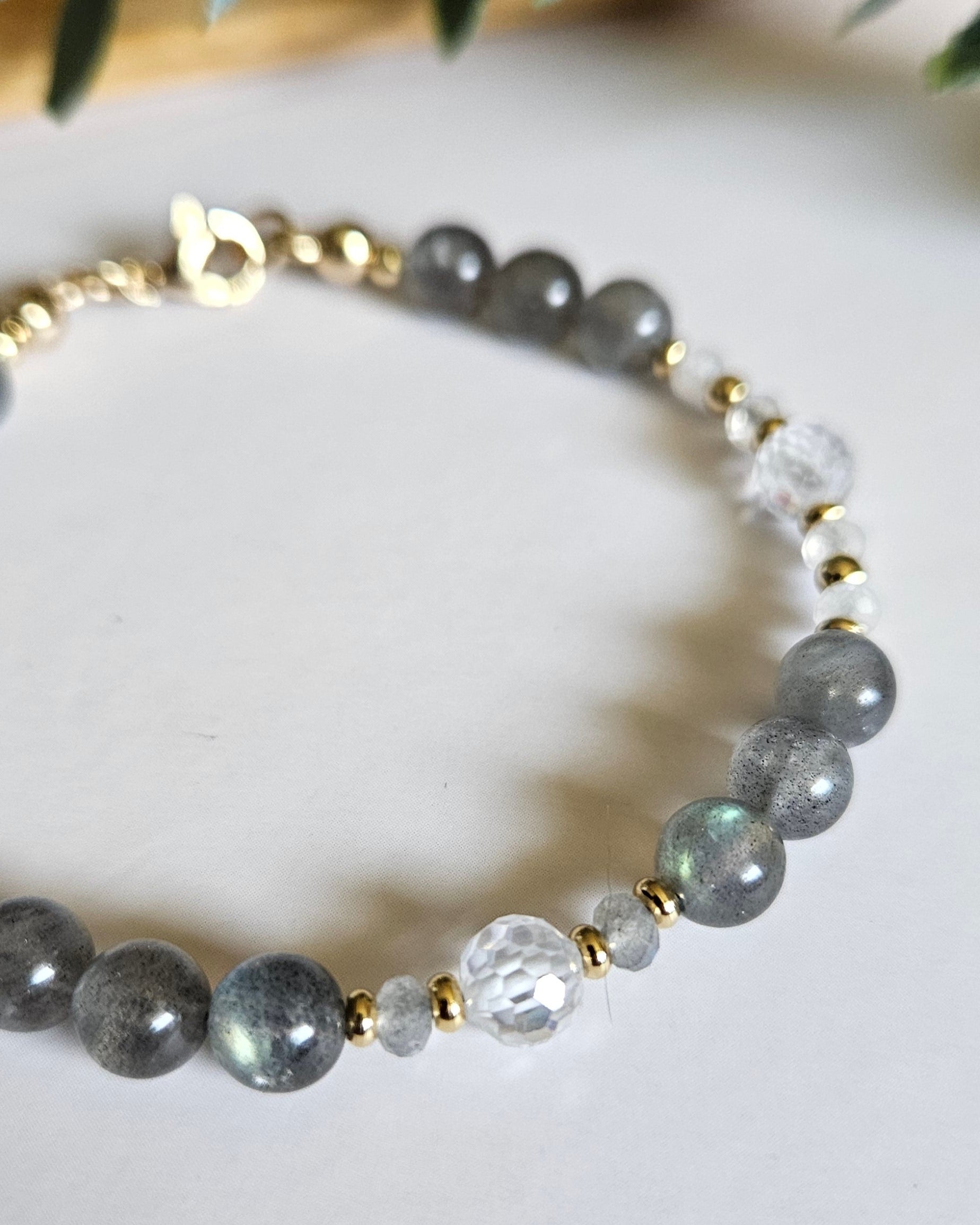 Close-up of Labradorite beads, faceted cubic zirconia, Moonstone rondelles and gold-plated accents