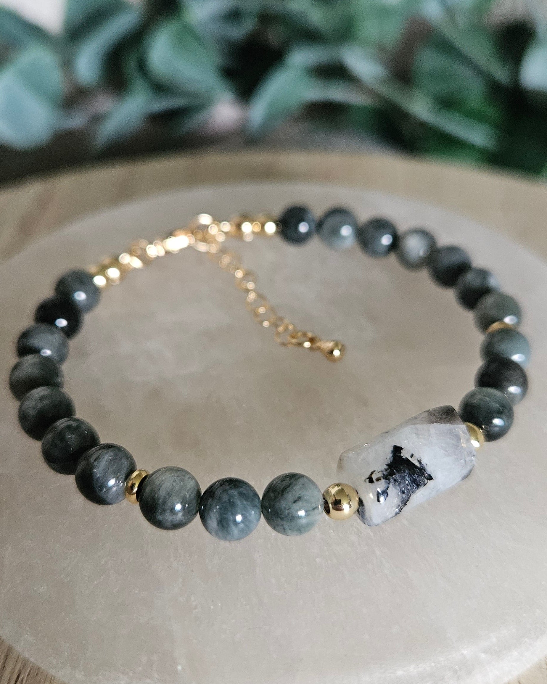 Close-up of the blue-grey Hawk’s Eye beads, included Moonstone focal and gold-plated accents