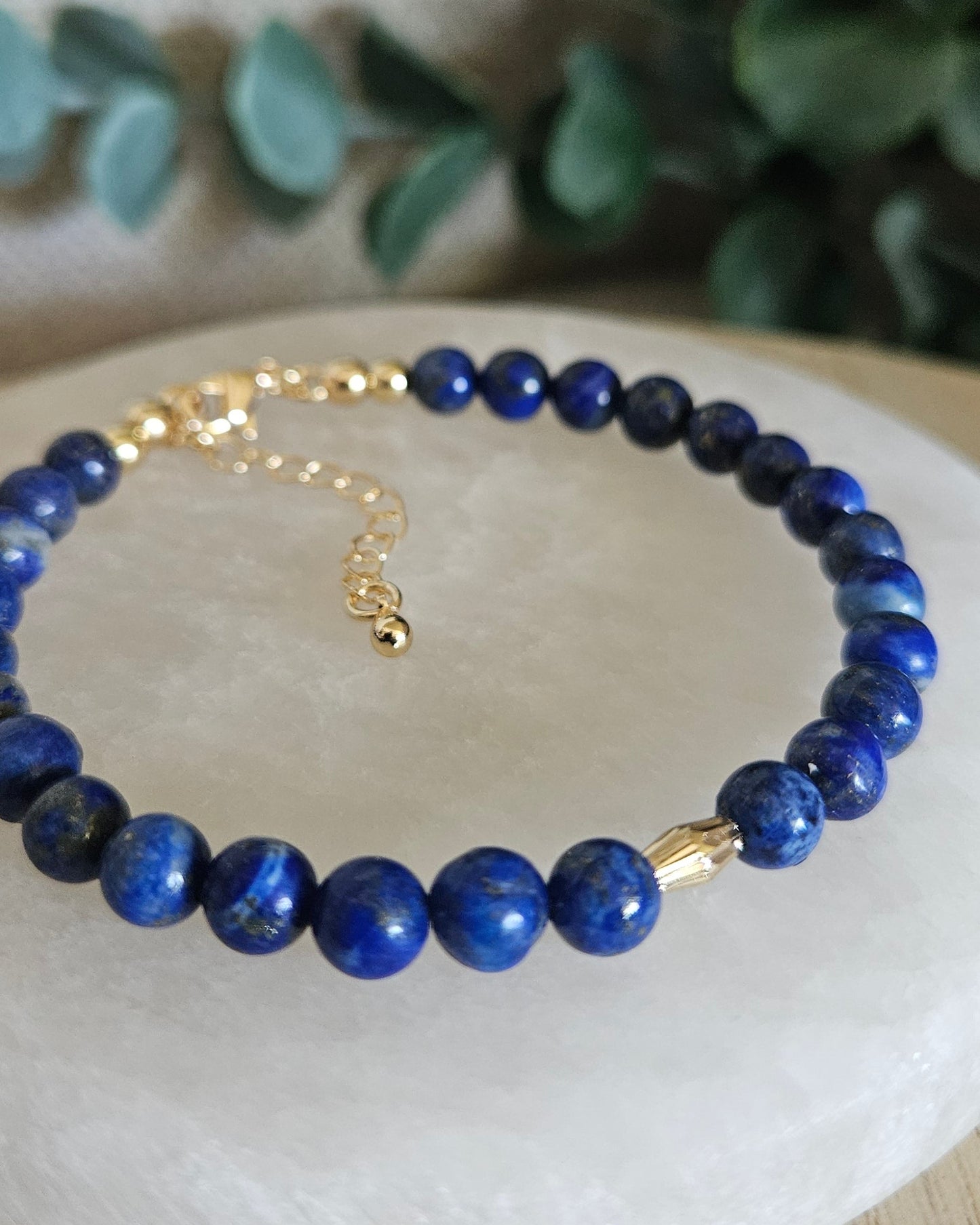 Close-up of the deep blue Lapis Lazuli beads and diamond-cut gold-filled oval focal accent