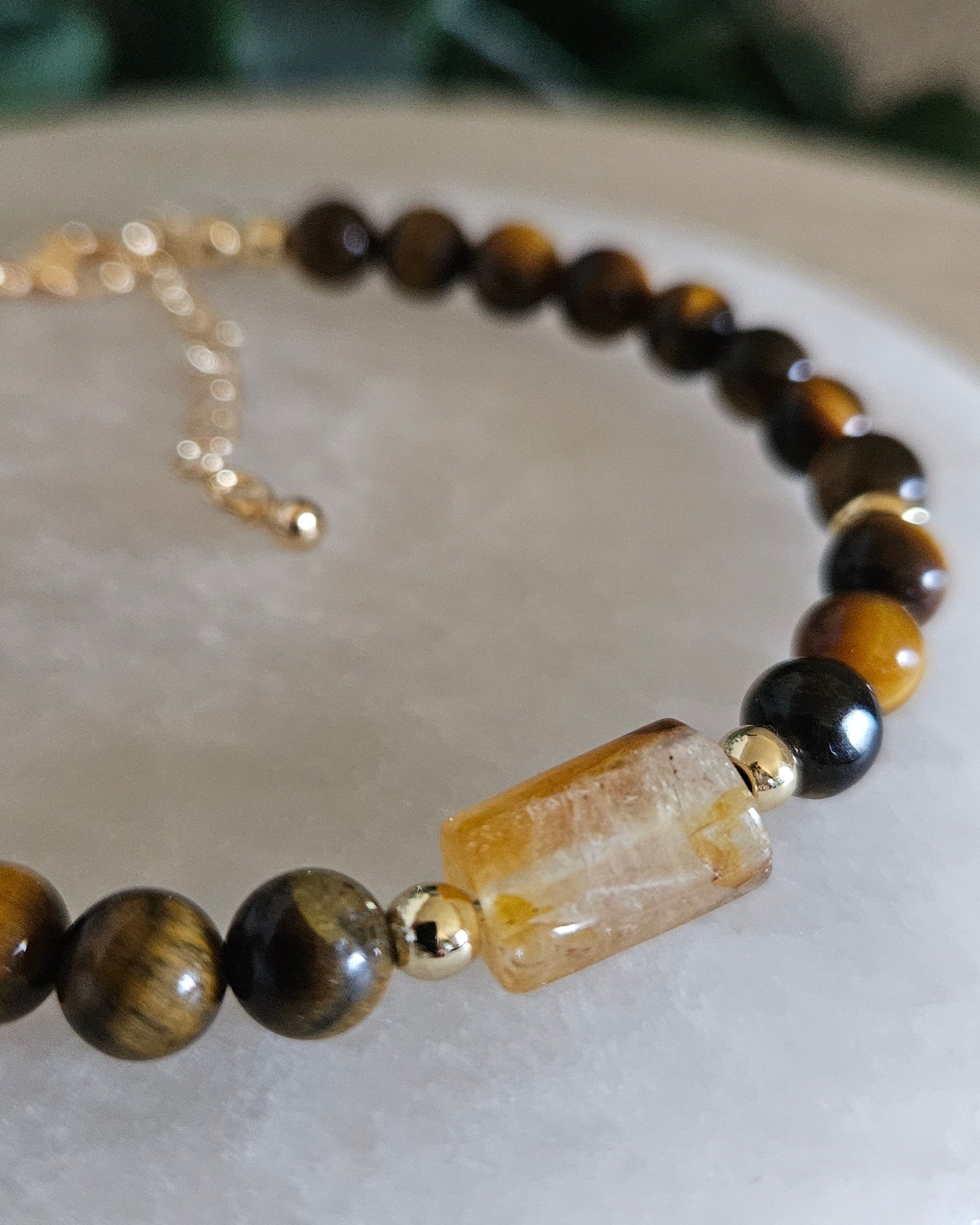 Close-up of the golden Citrine focal, striped Tiger’s Eye beads and polished gold-plated accents