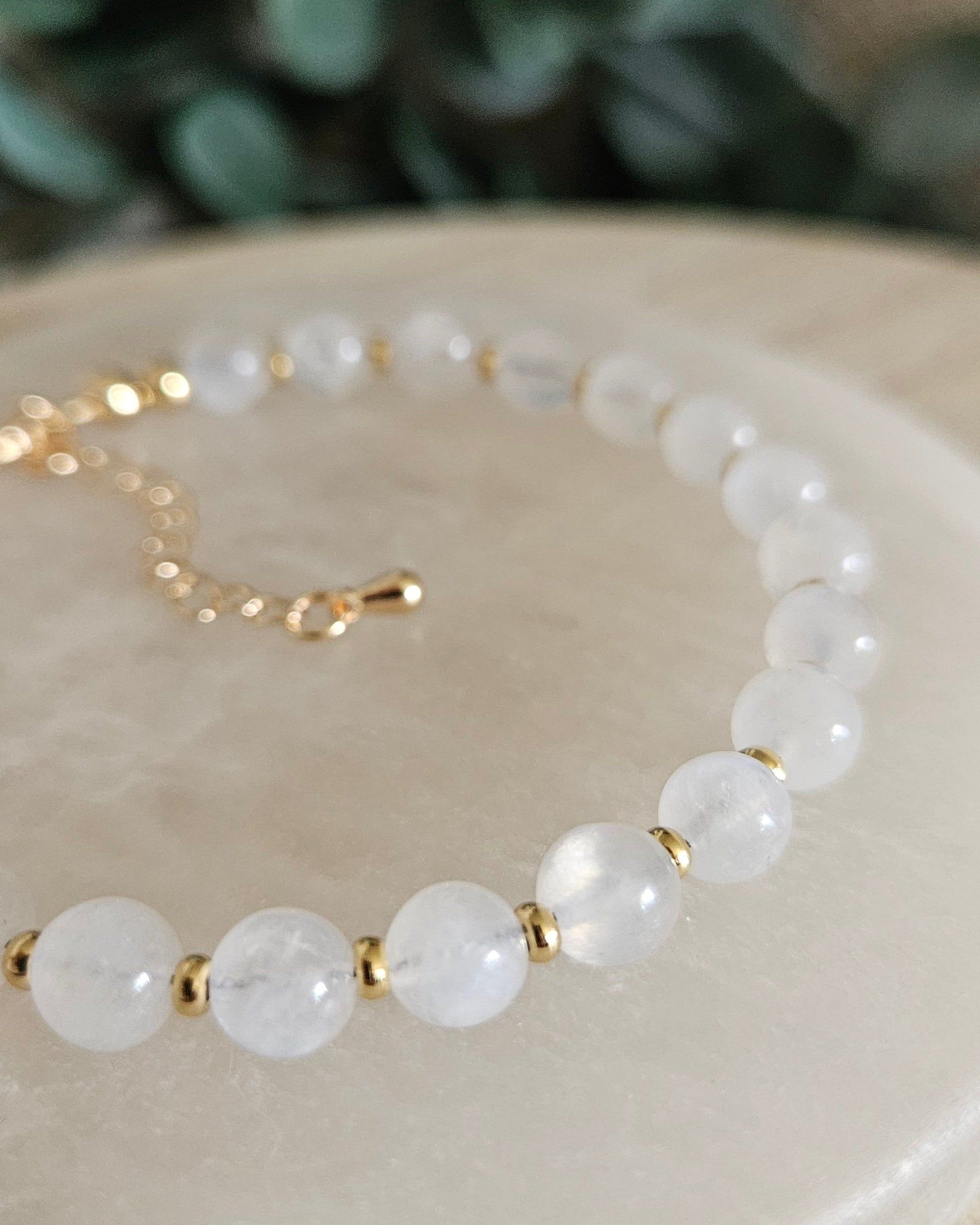 Close-up of glossy Moonstone beads and gold-plated spacers on the Echo bracelet