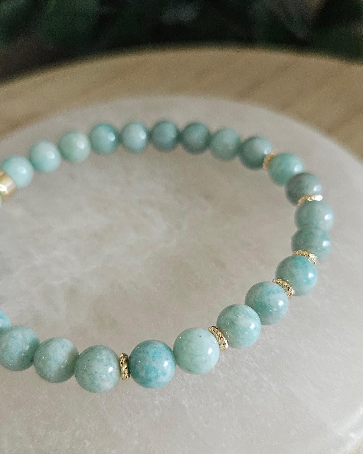 Close view of Amazonite beads with aqua green tones and 14k gold-plated spacer accents on selenite