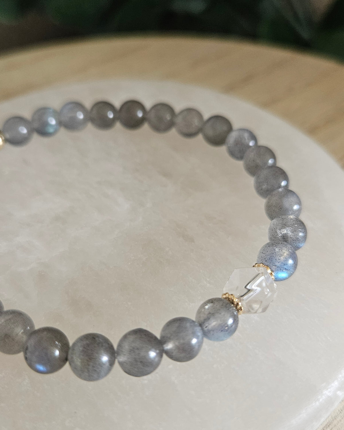 Close view of Labradorite beads with blue flash, Clear Quartz hexagon focal and 14k gold-plated spacer accents on selenite