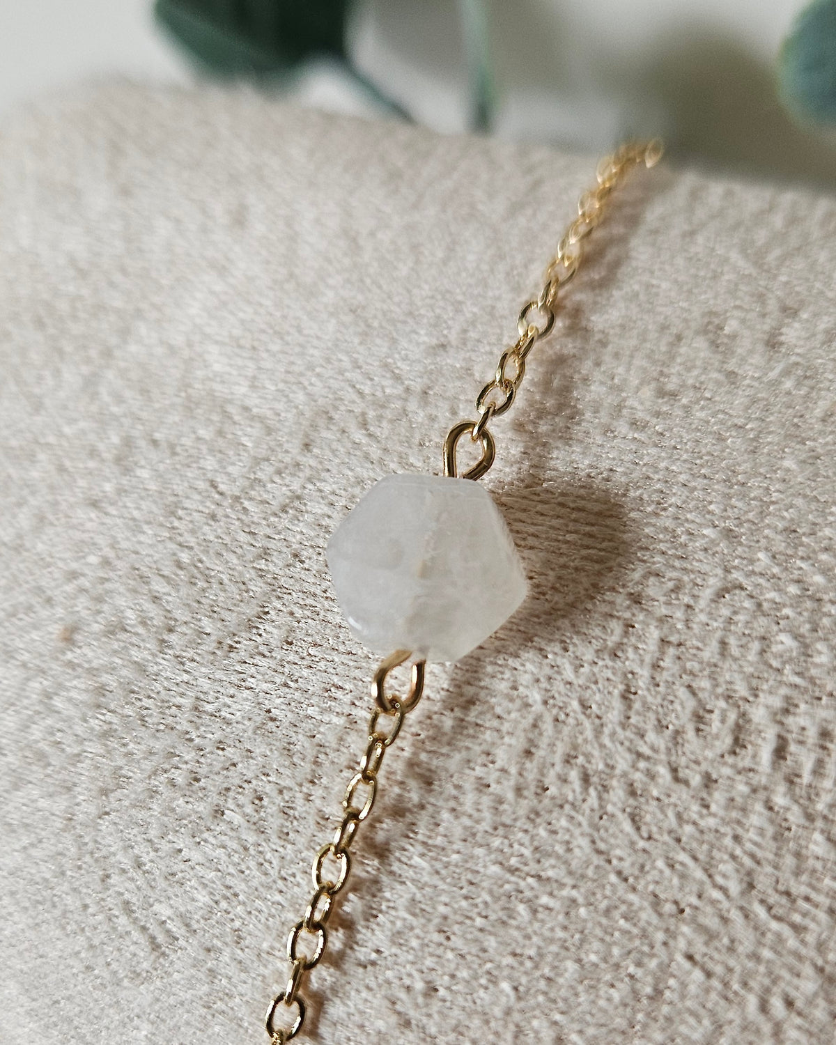 Close view of the Moonstone hexagon focal on a fine gold-plated chain bracelet with soft neutral styling