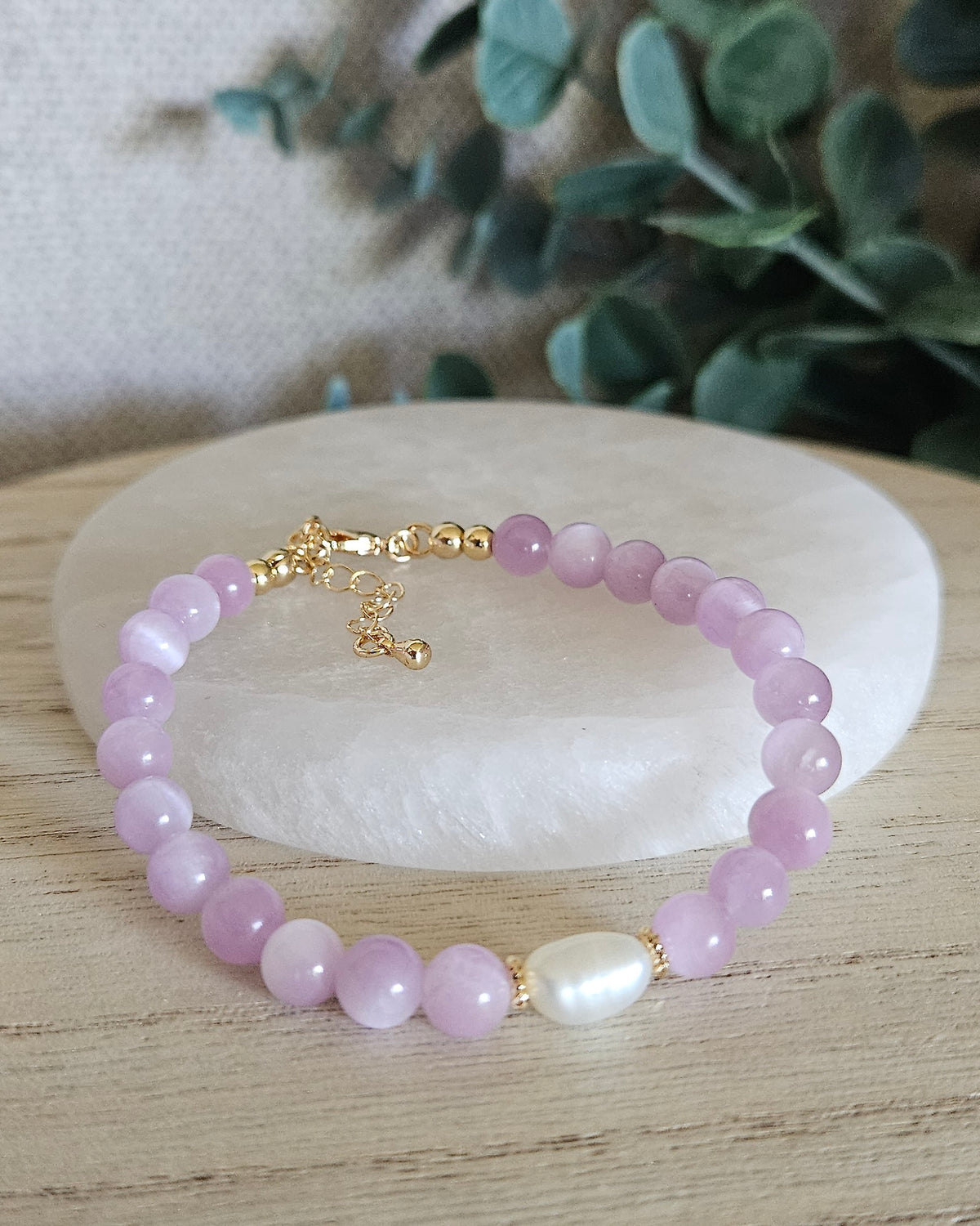 Front view of the Kunzite Embrace bracelet with 6mm lilac beads, freshwater pearl focal, 14k gold-plated clasp and extender chain