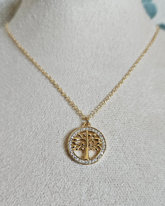 Front view of the Tree of Life necklace with a cubic zirconia pendant displayed on a beige jewellery bust