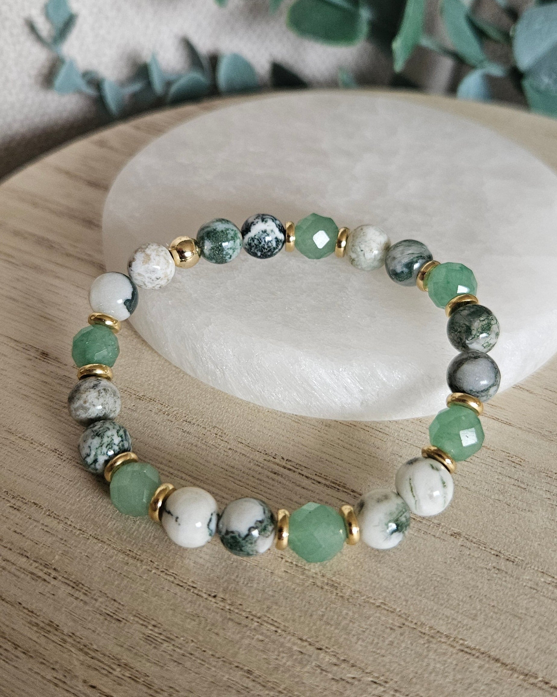 Full Green Aventurine and Tree Agate stretch bracelet displayed on a pale round stone tra