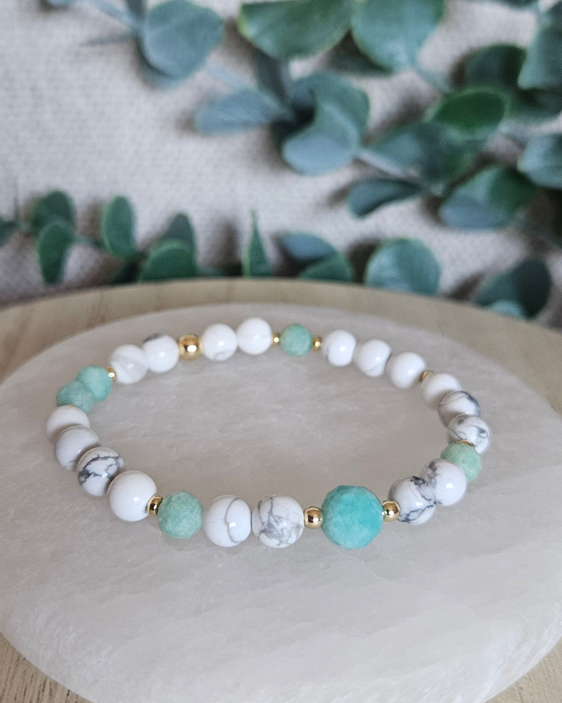 Howlite and Amazonite stretch bracelet with mint-green faceted accents and gold-plated spacers displayed on selenite