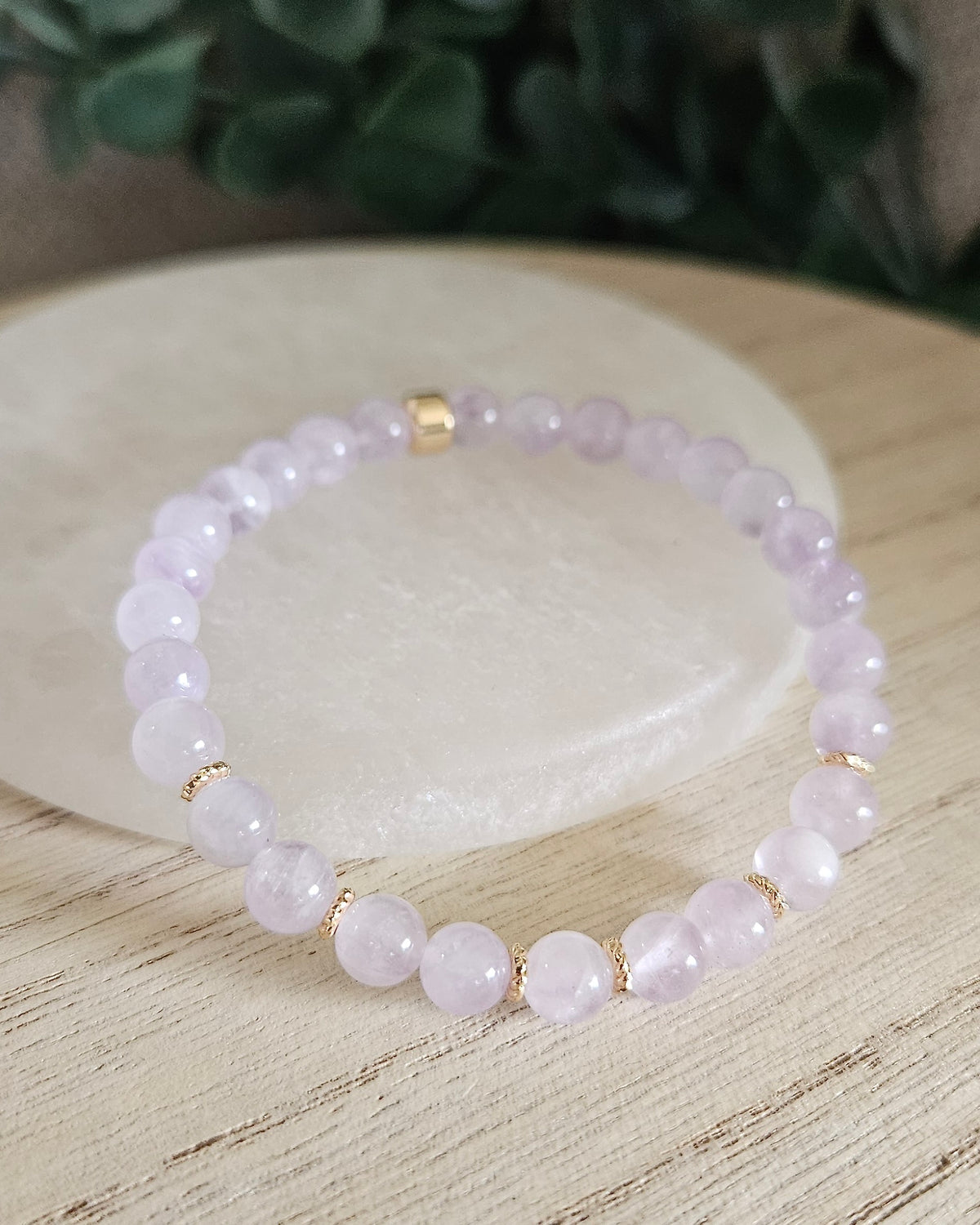 Lavender Amethyst Grace bracelet with pale purple gemstone beads, gold-plated accents and focal bead styled on selenite