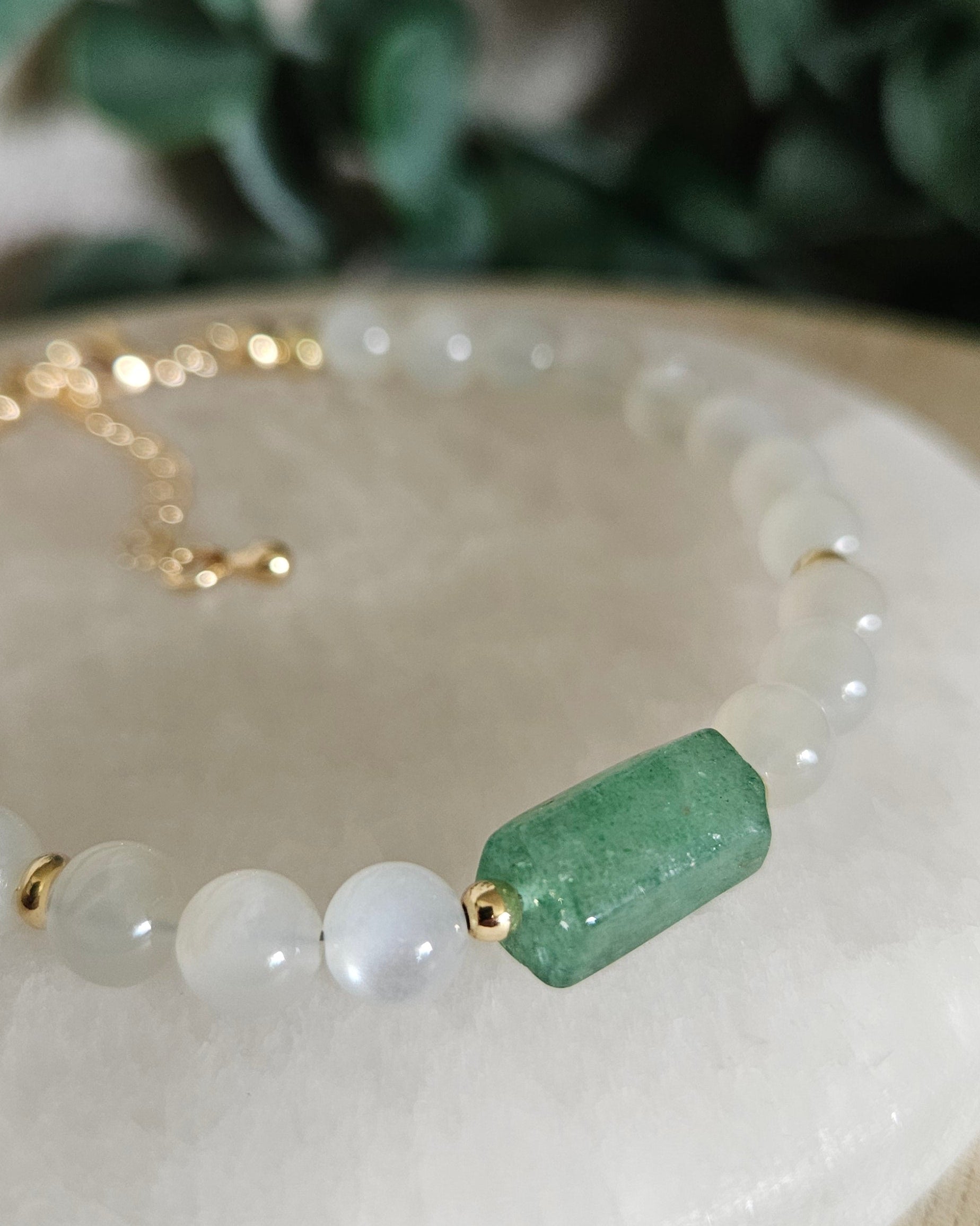 Close-up of the Green Strawberry Quartz barrel focal, White Moonstone beads and gold accent beads