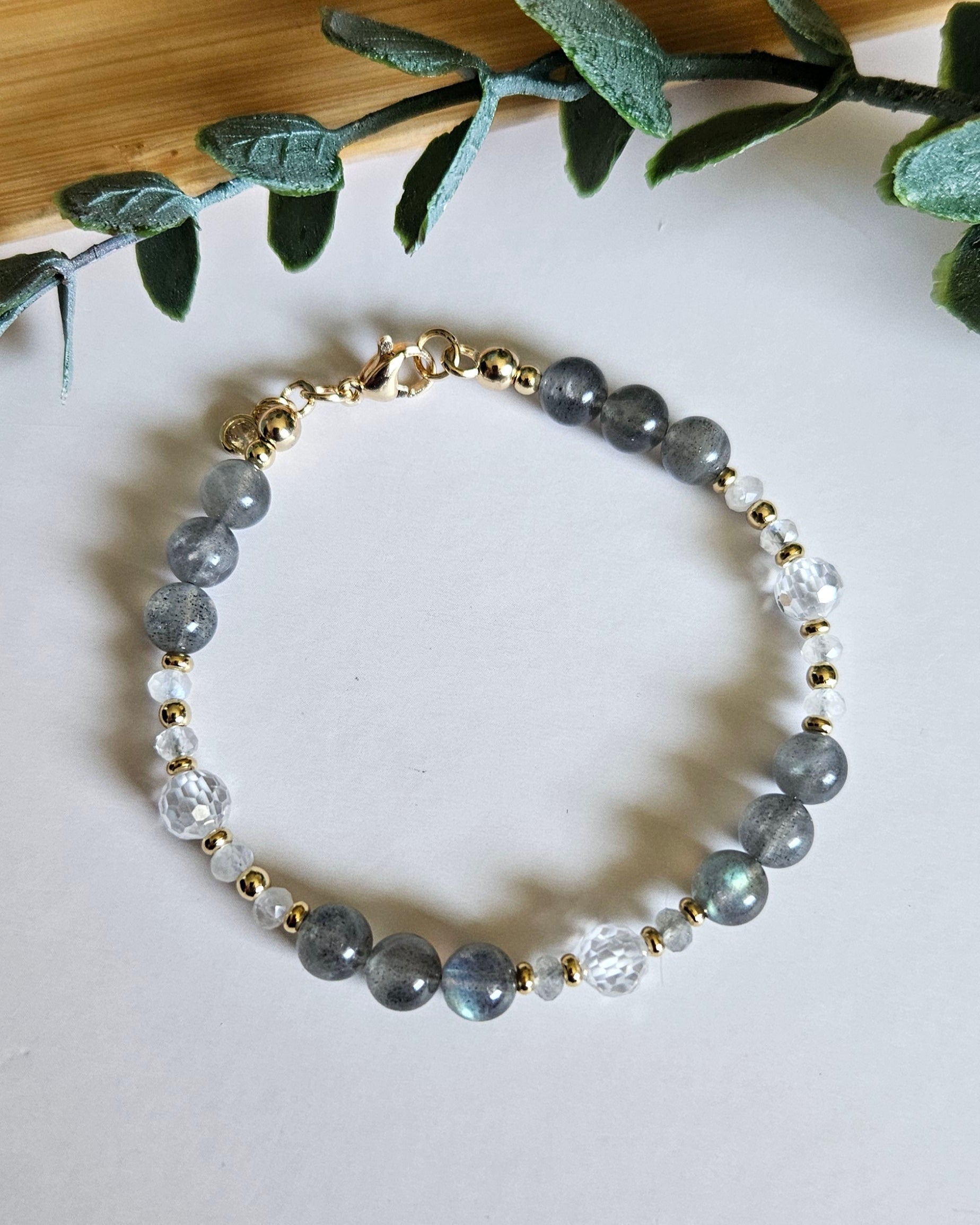 Overhead view of Labradorite, Moonstone and cubic zirconia bracelet with clasp and extender chain visible