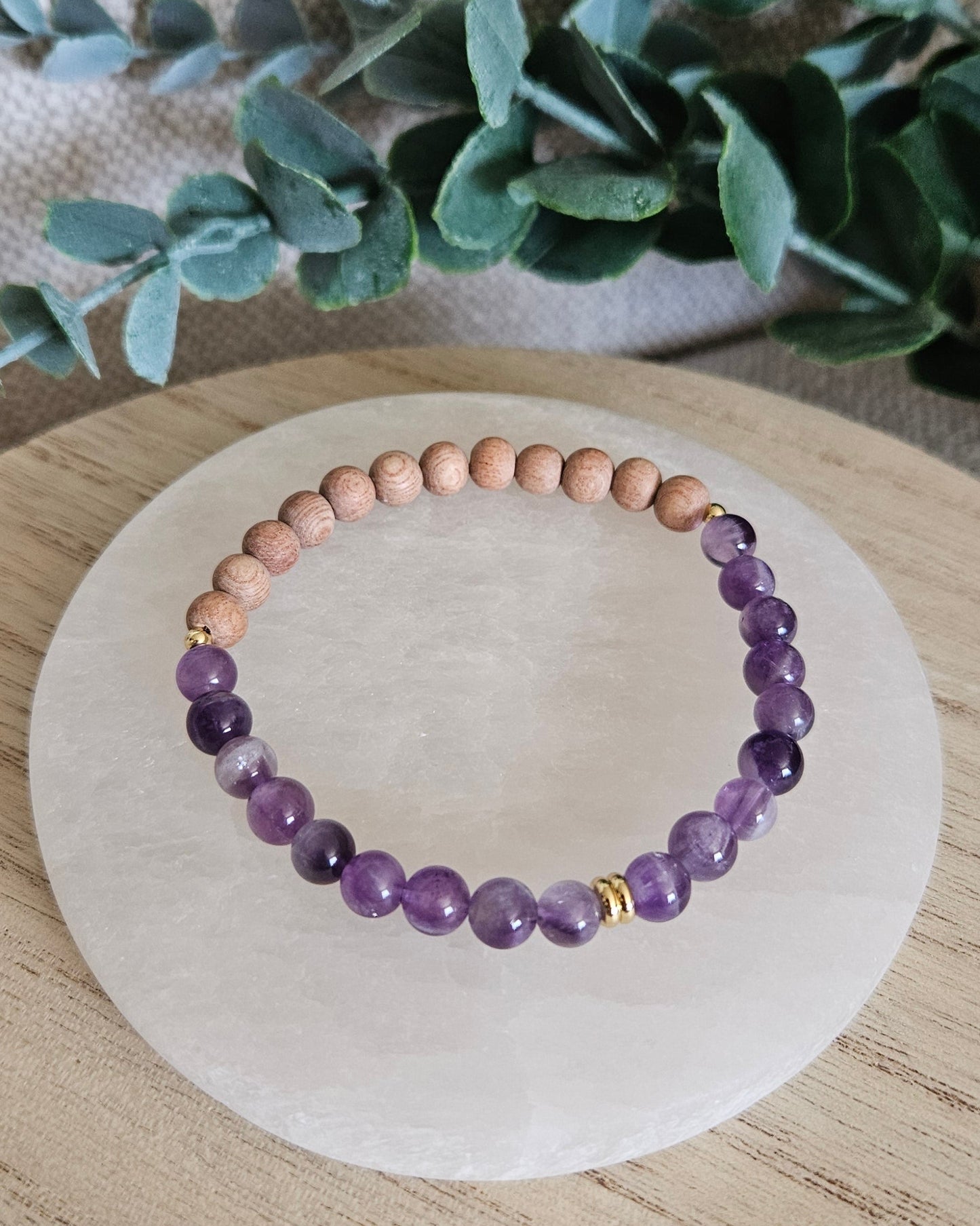 Overhead view of the Amethyst diffuser bracelet with natural Rosewood beads for essential oils