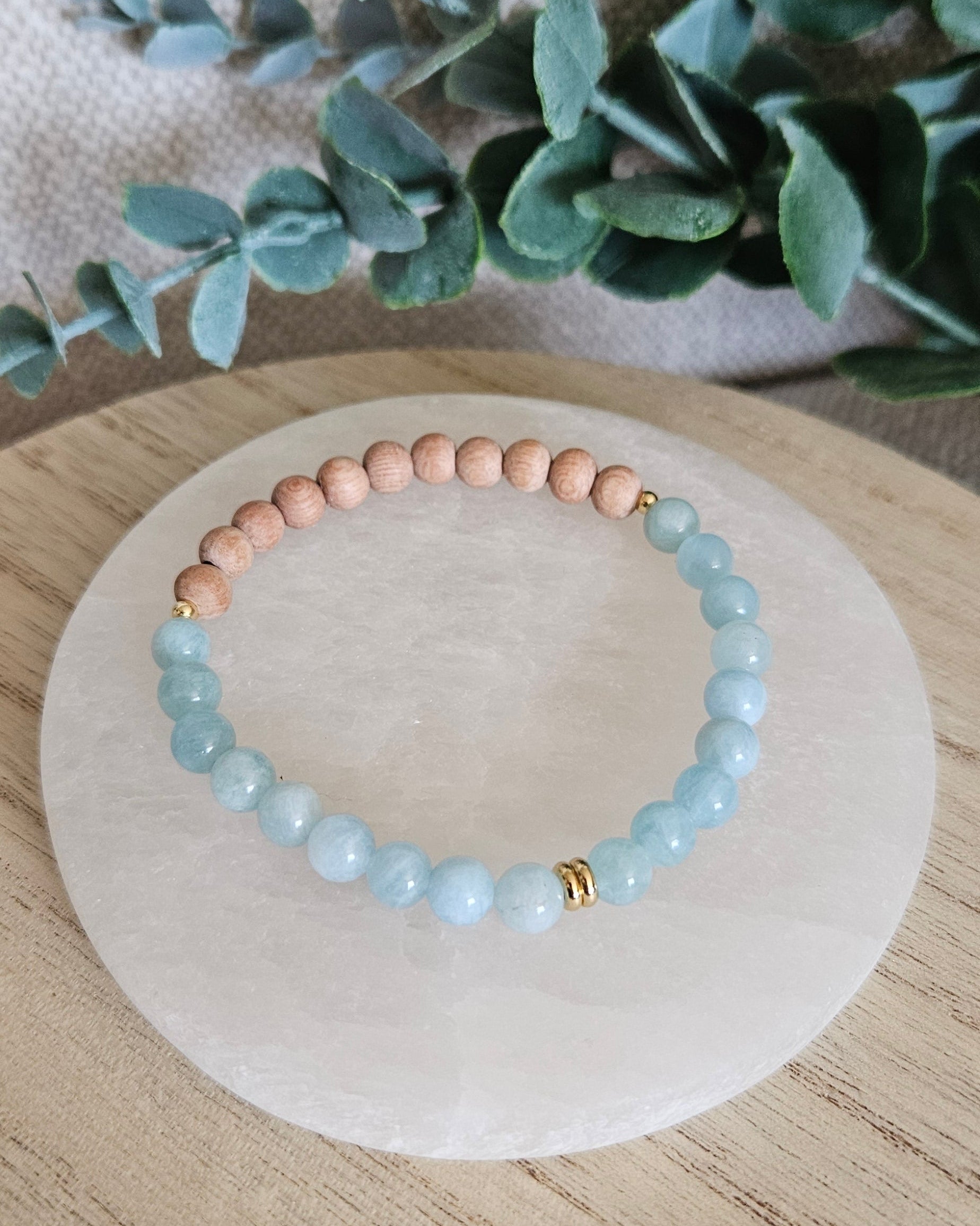 Overhead view of the Aquamarine diffuser bracelet with natural Rosewood beads for essential oils