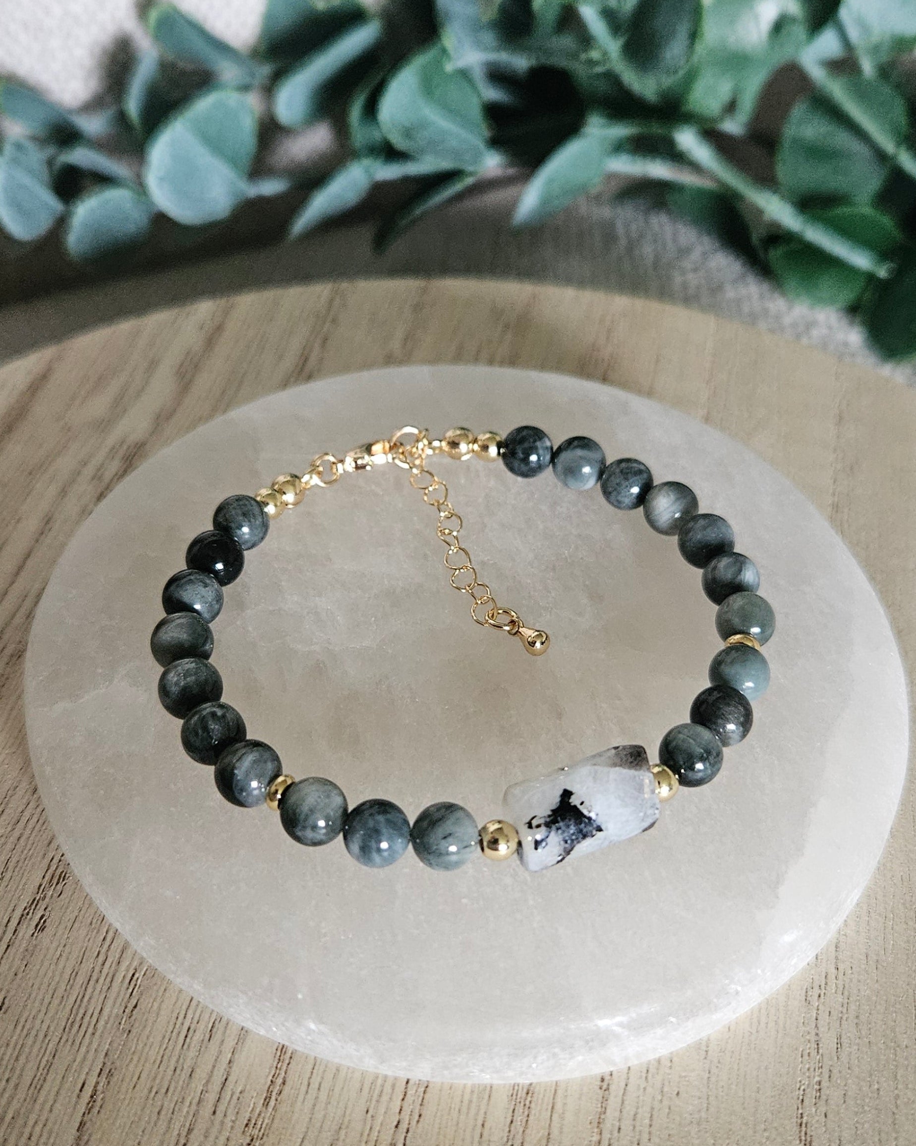 Overhead view of the Hawk’s Eye and Moonstone bracelet with gold-plated clasp and extender chain