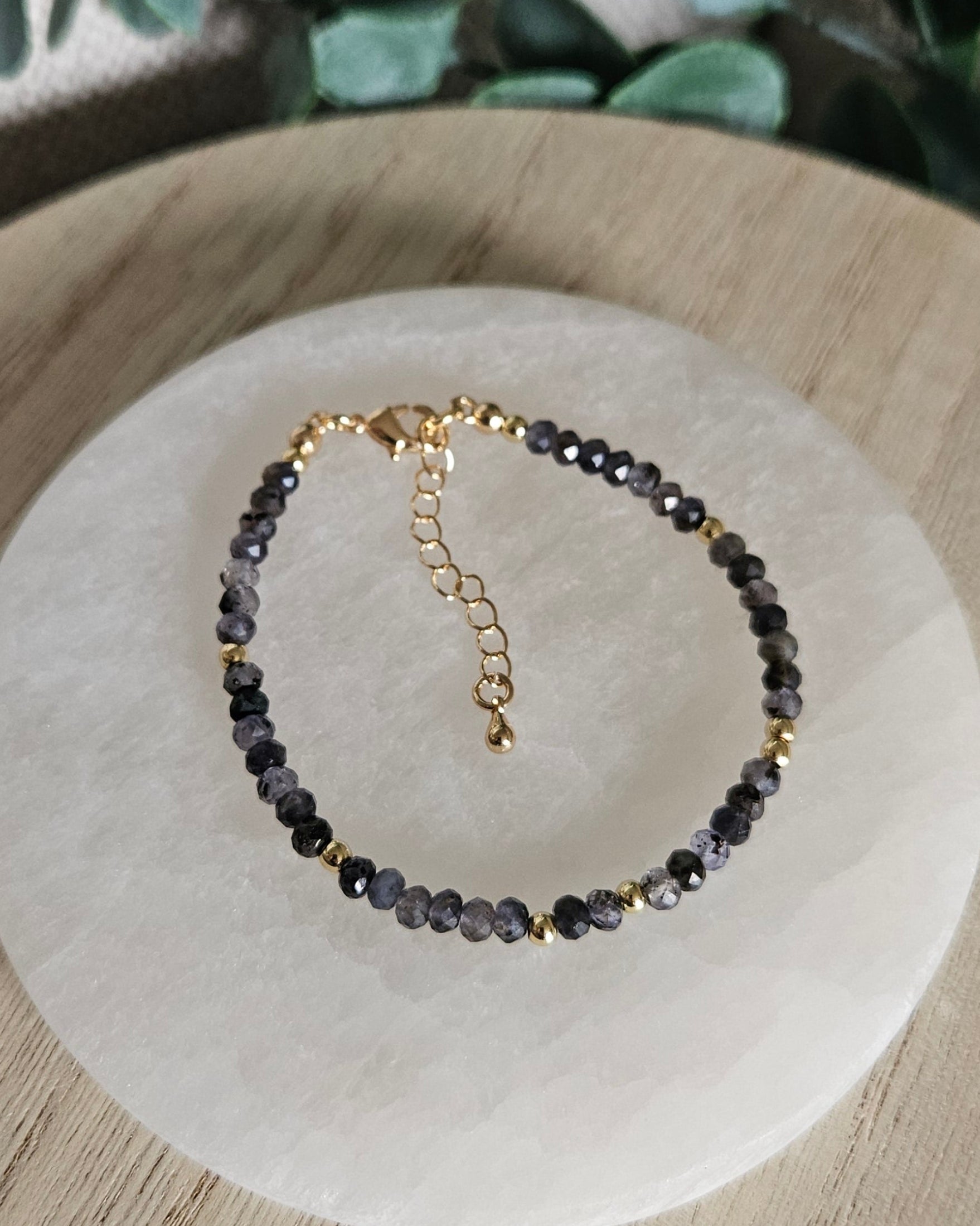 Overhead view of the Iolite bracelet with gold-plated clasp, spacer beads and extender chain