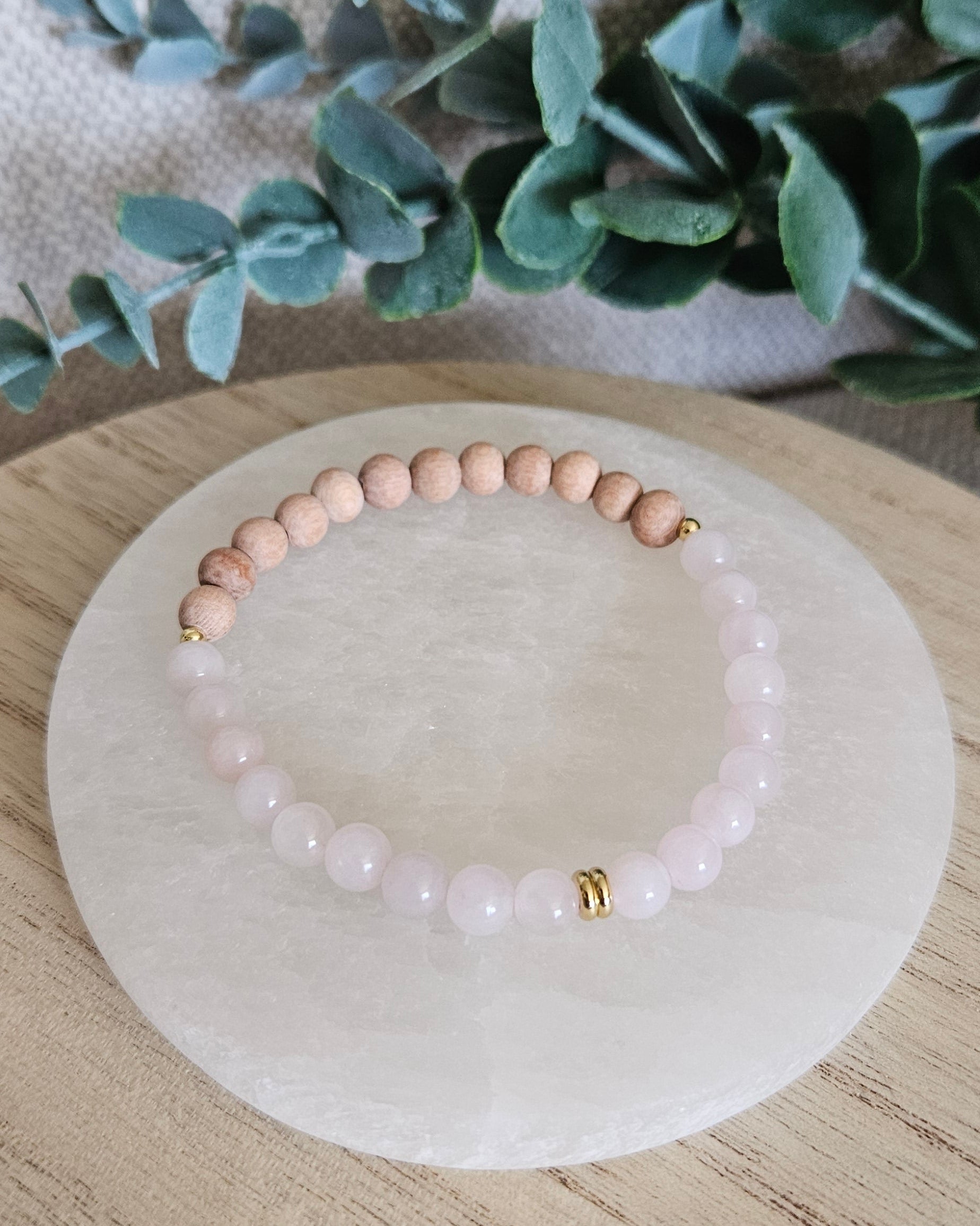 Overhead view of the Rose Quartz diffuser bracelet with natural Rosewood beads for essential oils