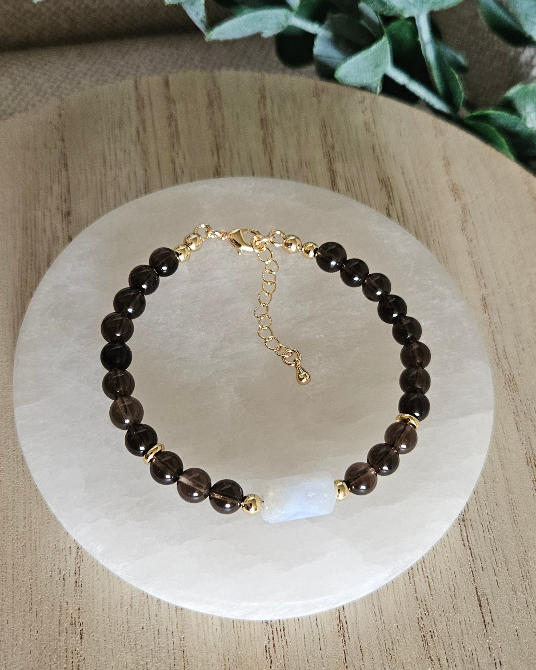 Overhead view of the Smoky Quartz and Blue Lace Agate bracelet with gold clasp and extender chain