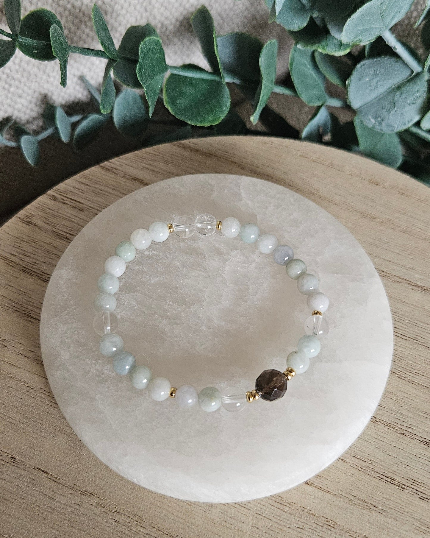 Overhead view of the pale Burmese Jade and Clear Quartz stretch bracelet with Smoky Quartz focal