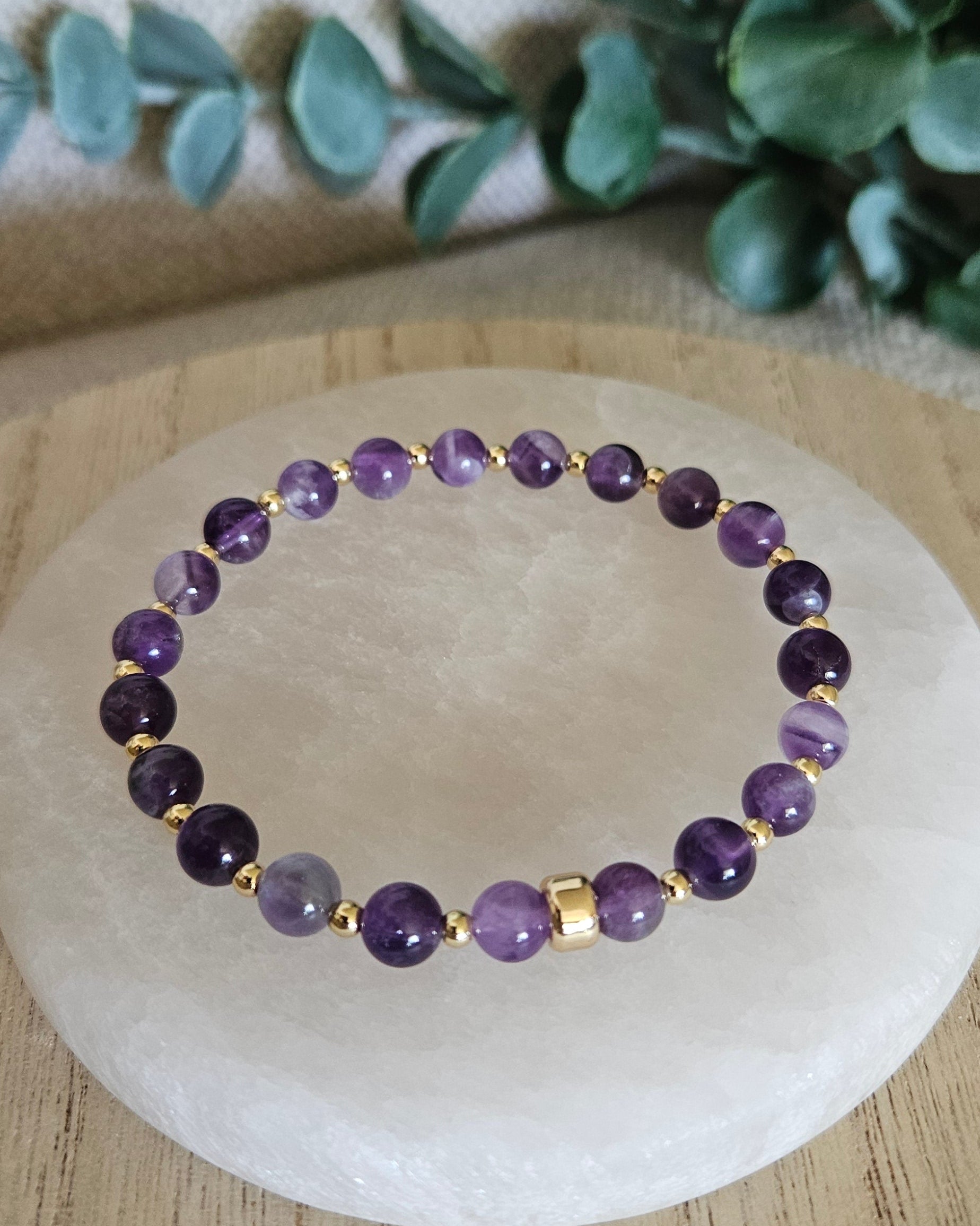 Overhead view of the purple Amethyst bead bracelet with gold-plated spacers and focal accent