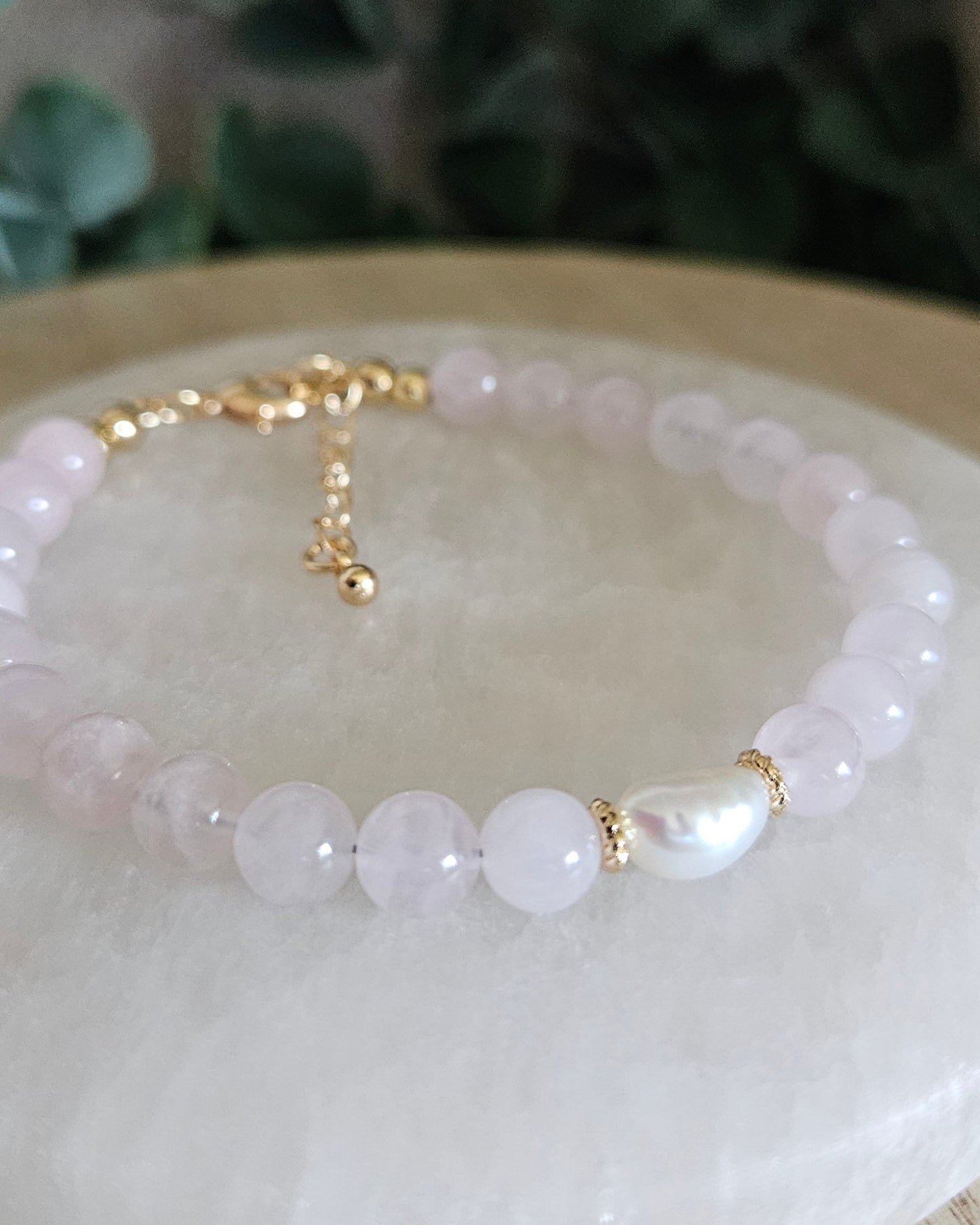 Close-up of Rose Quartz beads and a freshwater pearl focal with gold-plated floral spacers