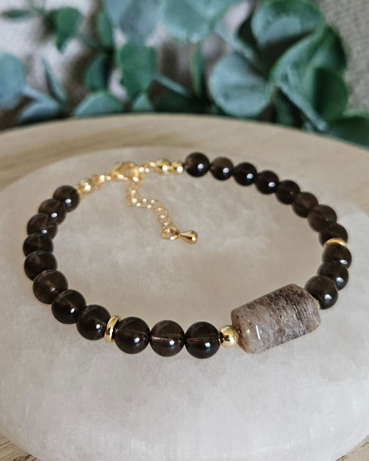 Smoky Quartz bracelet with a grey Angel Phantom Quartz focal, gold-plated accents and extender chain on selenite