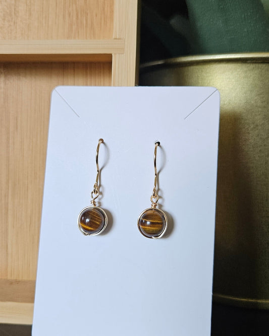 Tiger’s Eye wire wrapped earrings displayed on a white earring card with gold-plated stainless steel hooks