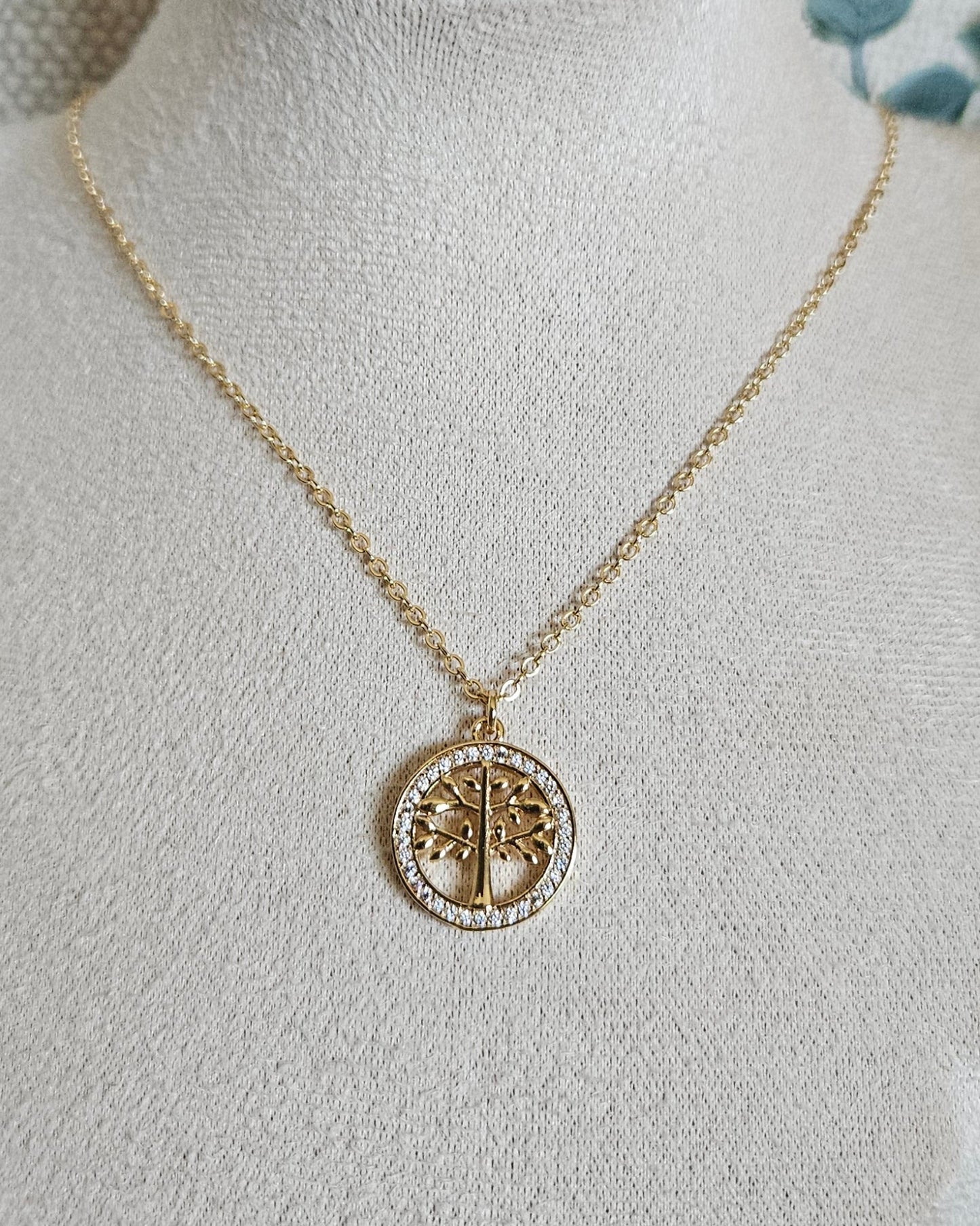 Full view of the 14k gold-filled Tree of Life necklace displayed on a beige jewellery bust
