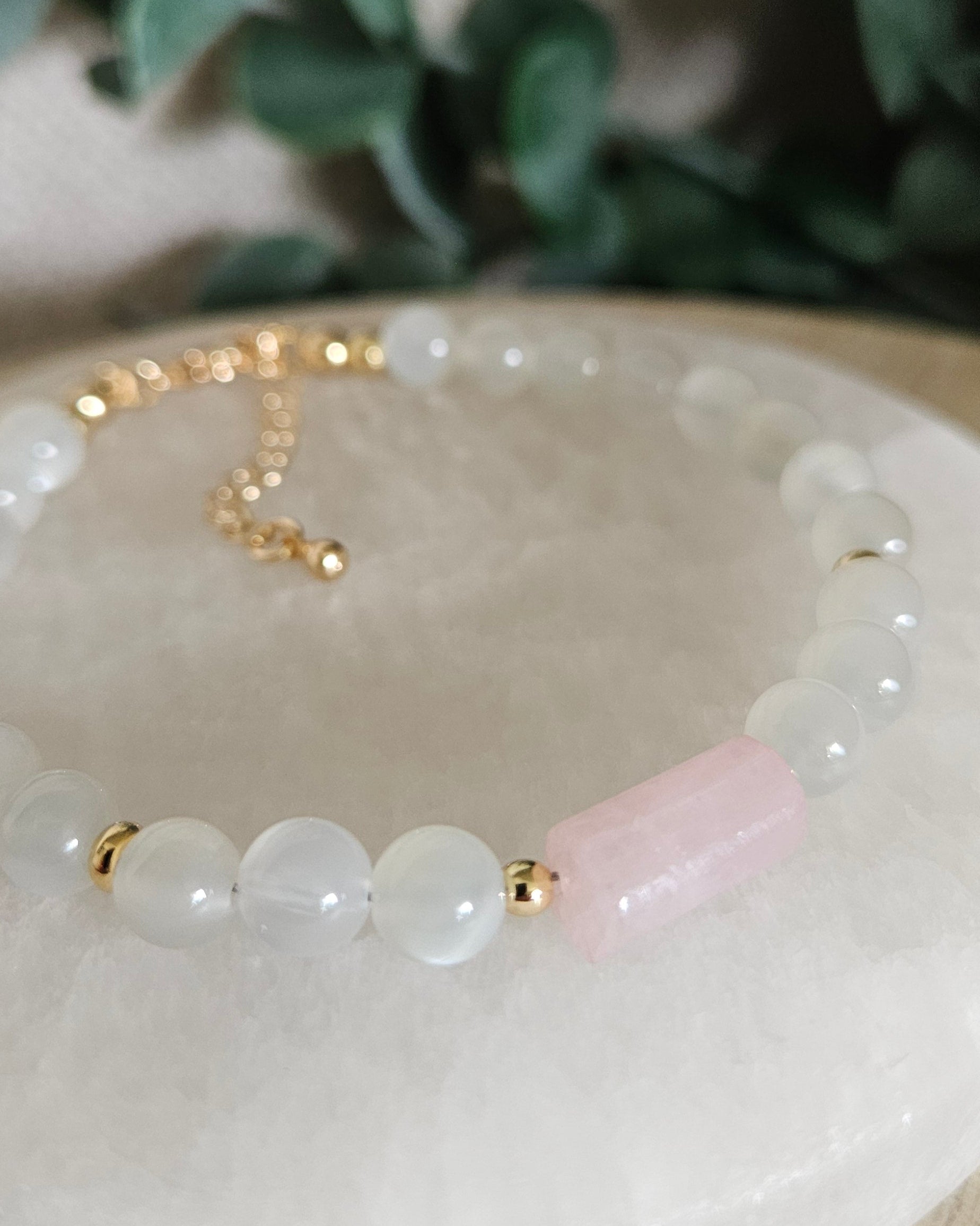 Close-up of the pale pink Rose Quartz barrel focal, White Moonstone beads and gold accent beads