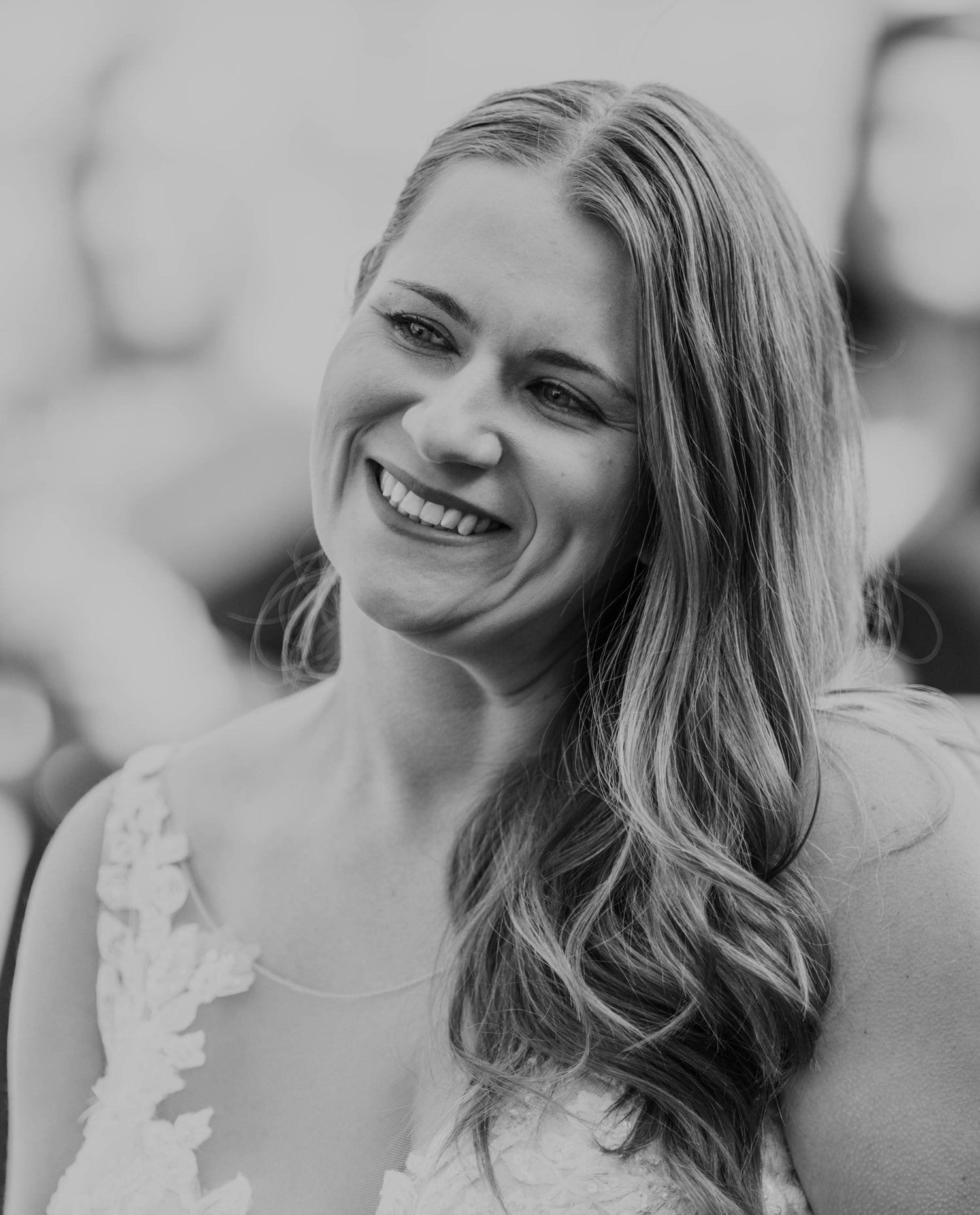 Black and white photo of a woman with long hair smiling.