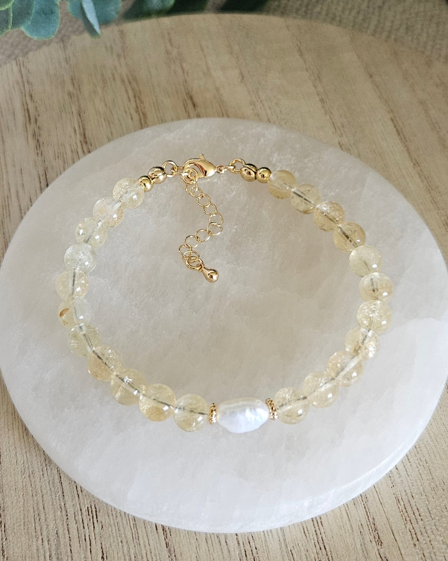 Overhead view of the Citrine Embrace bracelet with freshwater pearl focal, clasp and extender chain
