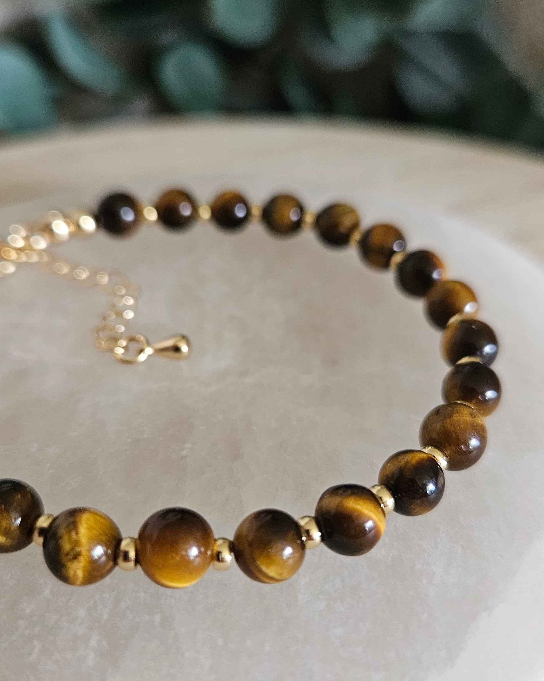 Close-up of brown Tiger’s Eye beads and gold-plated spacers on the Echo bracelet