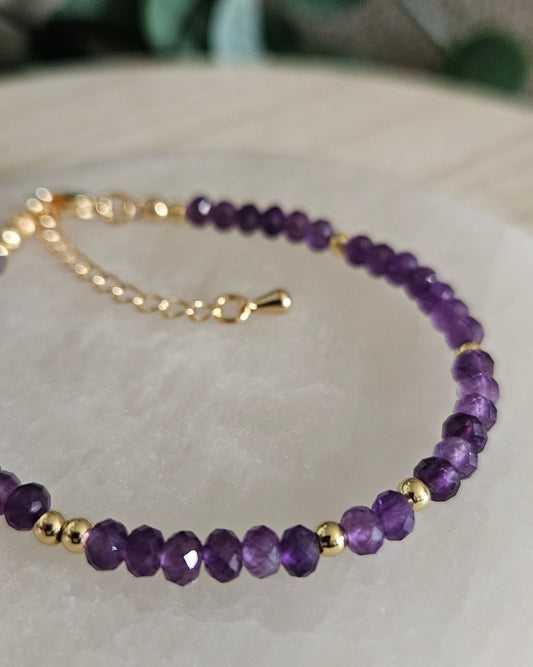 Close-up of the deep-purple faceted Amethyst rondelles with gold-plated spacers and extender chain