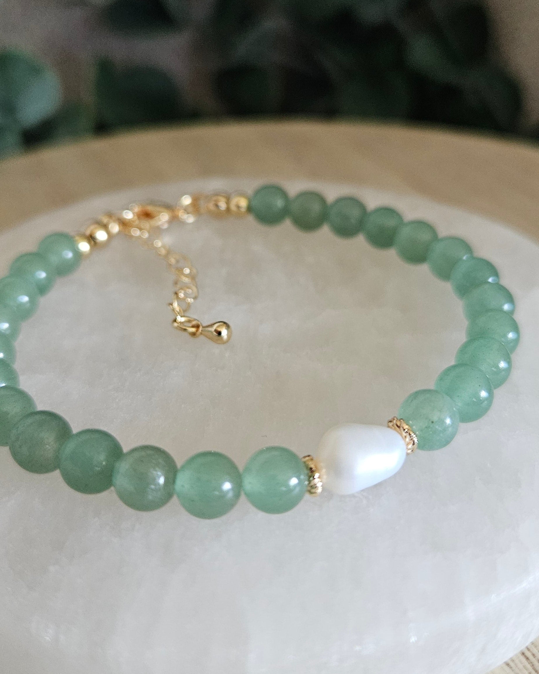 Close-up of Green Aventurine beads and a freshwater pearl focal with gold-plated floral spacers