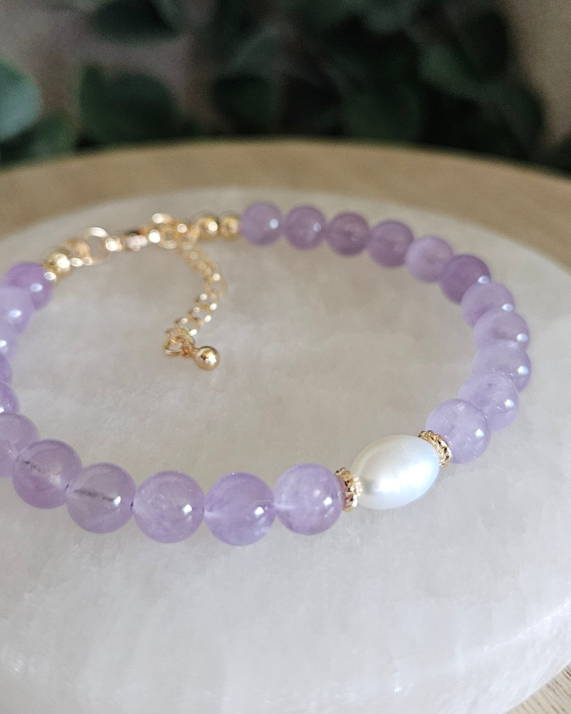 Close-up of Lavender Amethyst beads and a freshwater pearl focal with gold-plated floral spacers