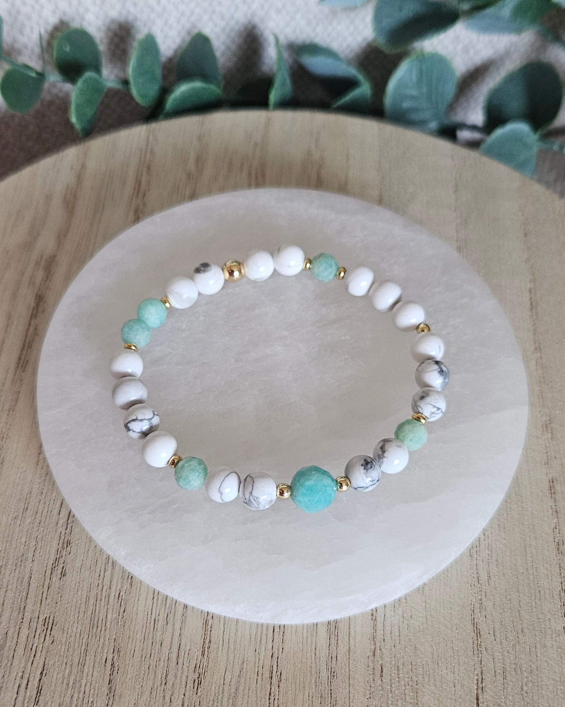 Overhead view of the veined white Howlite bracelet with faceted Amazonite beads and larger focal