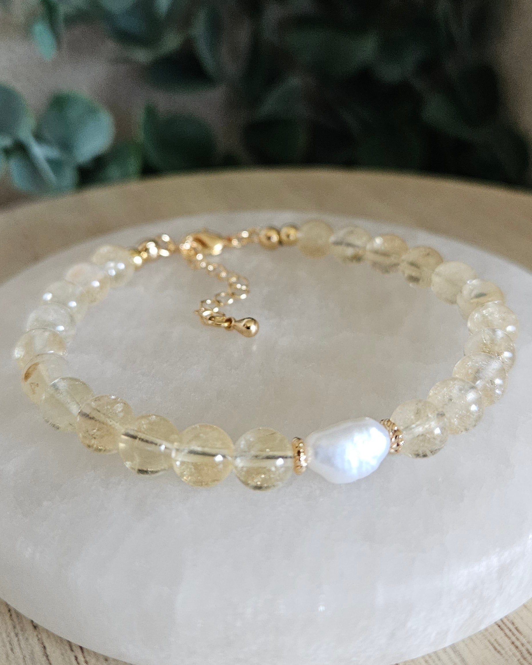 Close-up of Citrine beads and a freshwater pearl focal with gold-plated floral spacers